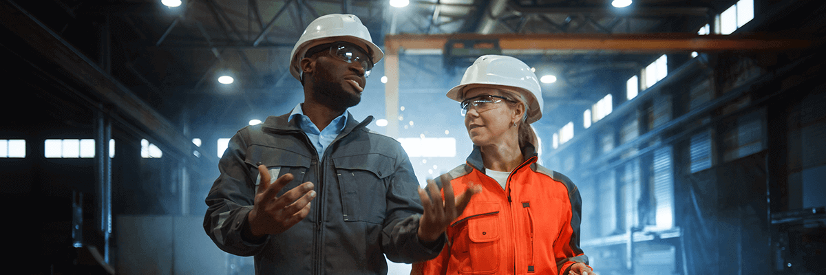A Male and Female Construction Worker Discussing Plans