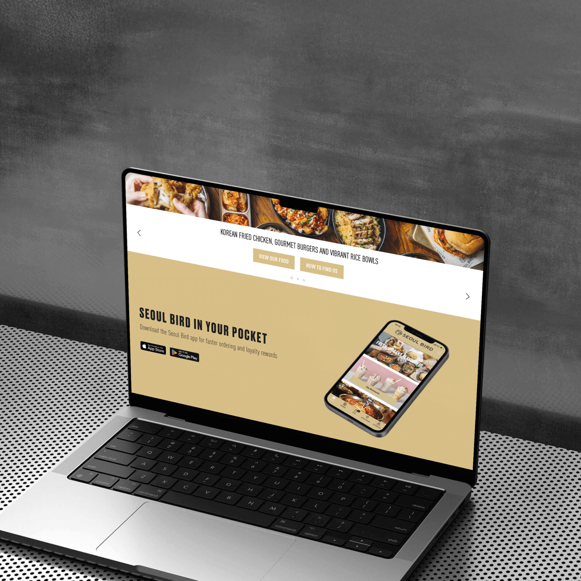 A laptop displays a website featuring food offerings, highlighting a mobile app titled "Seoul Bird in Your Pocket." The layout includes vibrant images of dishes and navigational links for user engagement.