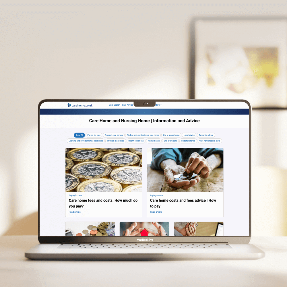 A laptop displays a webpage focused on care homes and nursing home advice, featuring articles about costs and financial guidance, alongside images of coins and hands.