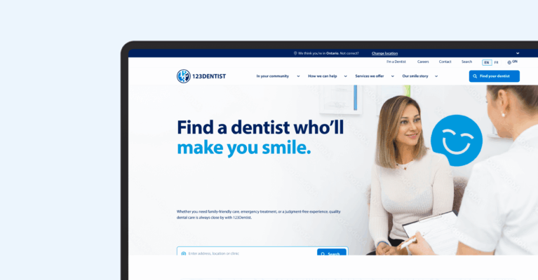 A laptop displaying a dental practice website with the tagline "Find a dentist who'll make you smile." The clean interface shows a patient at reception and features a blue tooth logo, representing the practice's patient-focused approach.