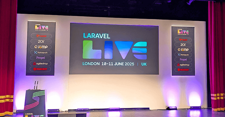 Conference stage for Laravel Live event in London, scheduled for June 10-11, 2025. The stage has a large screen displaying the event name and date, with sponsor logos on side banners.