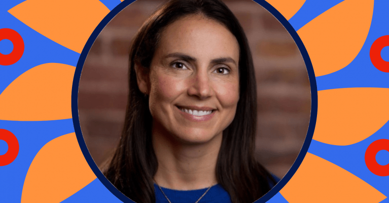 Smiling attendee at WordCamp Europe Kraków 2026, framed by a blue and orange floral design.